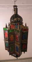 A vintage Moroccan hanging lantern, having multicoloured glass panels with etched decoration.