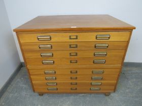 A mid-century teak planning chest of usable proportions, having eight long drawers with brass