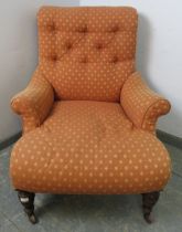 A low and deep Victorian armchair in the manner of Howard & Sons, with scrolled back,