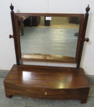 A Regency Period mahogany gentlemen’s swing vanity mirror, the reeded uprights with turned