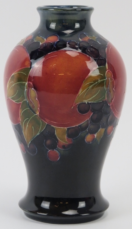 A William Moorcroft Burslem Pomegranate pattern vase, circa 1920. Signed W. Moorcroft in green