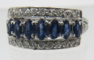 A fine white metal sapphire & diamond ring. Seven marquise cut sapphires, approx 5mm x 3mm in centre