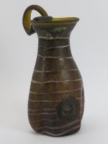 A Mediterranean glass jug with seal, probably Italian or Greek. Trail decoration throughout. 28.3 cm