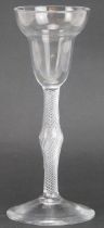 A Georgian English wine glass, mid 18th century. With a centrally knopped air twist stem and