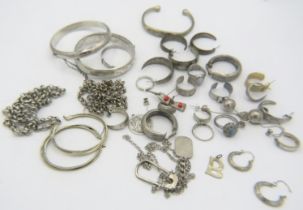 A large collection of silver & white metal items to include two silver engraved bangles, two
