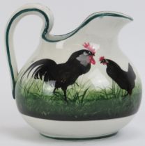 A Wemyss ware jug decorated with black hens and cockerels. Signed beneath. 16 cm height. Condition