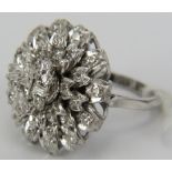 An 18ct white gold large diamond cluster ring consisting of four layers of diamonds. The top set