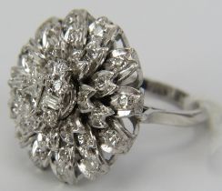 An 18ct white gold large diamond cluster ring consisting of four layers of diamonds. The top set