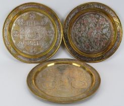 Three Middle Eastern profusely decorated brass coffee trays, 20th century. Comprising two overlaid