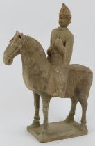 A Chinese pottery figure of a horse and rider, probably 20th century. Modelled in the Tang dynasty