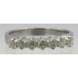 An 18ct white gold seven stone diamond ring, round brilliant cut diamonds, approx 0.50cts, size O.