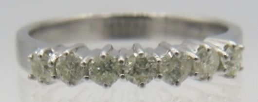 An 18ct white gold seven stone diamond ring, round brilliant cut diamonds, approx 0.50cts, size O.