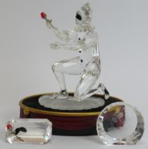 A Swarovski ‘Masquerade Harlequin’ crystal glass figurine, 2001 SCS edition. Glass plaques, stand,