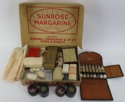 A vintage First Aid kit, medicine glasses and apothecary bottle in a case. (Quantity). Condition