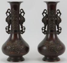 A pair of Chinese twin handled bronze vases, early 20th century. (2 items) 27 cm height. Condition