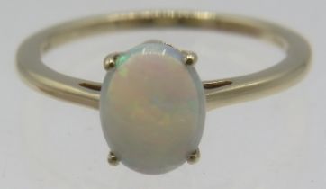 A 10ct yellow gold oval cabochon white opal ring, size P, boxed. Approx weight 2.2 grams.