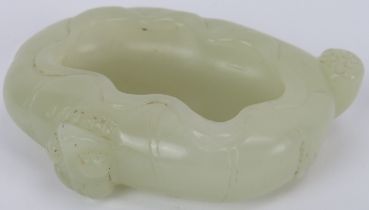 A Chinese pale celadon jade brush washer cup, early 20th century. Carved in the form of a furled