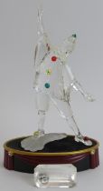 A Swarovski ‘Masquerade Pierrot’ crystal glass figurine, 1999 SCS edition. Glass plaque, stand,