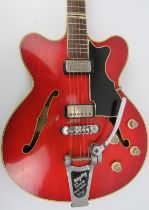 A Hofner Verithin Bigsby semi acoustic electric guitar, dated 1963. With a cherry finish body.