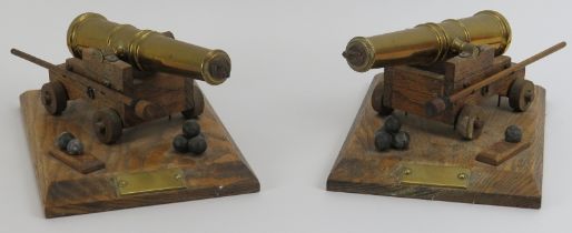 A pair of vintage brass and oak desk top cannons, 20th century. (2 items) Both cannons mounted on