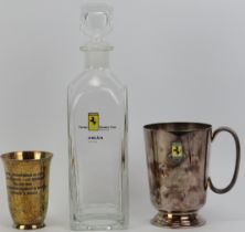 Automobilia: A Ferrari Owners Club glass decanter bottle, plated silver rally tankard and associated
