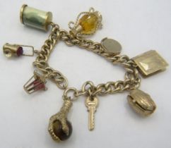 A 9ct gold link charm bracelet with nine various charms, seven of which are hallmarked 9ct gold.