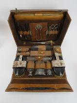 A vintage leather cased gentleman’s travelling toiletry set, early 20th century. The interior fitted