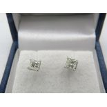 A pair of 14ct white gold princess cut diamond solitaire stud earrings with screw backs. Diamonds