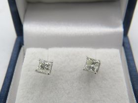 A pair of 14ct white gold princess cut diamond solitaire stud earrings with screw backs. Diamonds
