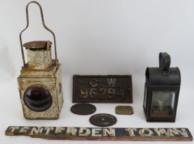 A group of vintage railway memorabilia items. Items include two lanterns, three cast metal plaques