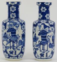 Two Chinese blue and white porcelain vases, late 19th century. Both of rouleau form, the exteriors