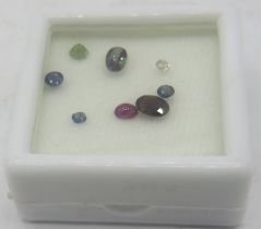 A collection of unmounted gemstones: One cabochon ruby (approx 0.26cts), one garnet (approx 0.