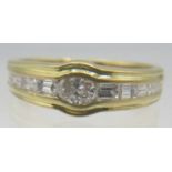 An 18ct yellow gold diamond set ring. The central oval diamond approx 0.2cts with four graduated