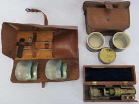 A vintage cased field microscope, specimen dishes in a leather pouch together with horse riding
