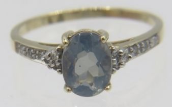 A 9ct yellow gold ring set with oval smoky clue quartz with diamond shoulders, size N, boxed. Approx