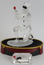 A Swarovski ‘Masquerade Harlequin’ crystal glass figurine, 2001 SCS edition. Glass plaque, stand,