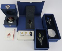 A Swarovski SCS ‘Vase of Roses’ together with three tulips and a stand. Certificates and boxes