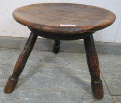 An 18th century country made sycamore and ash Welsh stool, the dished top on canted turned supports.