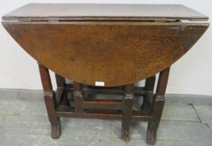 An 18th century oak gate-leg table of small proportions, with single drawer, on turned and block