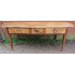 A rustic antique French chestnut farmhouse table, having three drawers to one side with cast iron