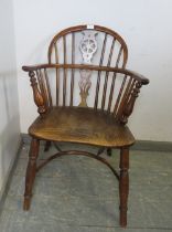 A 19th century elm and yew wood wheelback chair, on turned supports with crinoline stretcher (a/