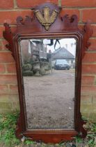 A Georgian mahogany wall mirror within a shaped surround, having relief carved Prince of Wales