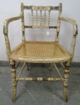 A Regency Period faux bamboo elbow chair, the beech frame retaining the original polychrome
