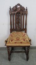 A 19th century Carolean Revival carved oak single chair/hall chair, with caned seat and machined