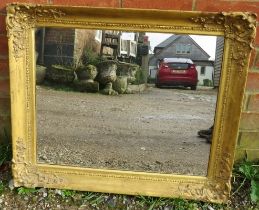 An ornate 19th century moulded gilt gesso frame with later added mirror plate. H61cm W74cm D6cm (