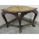 An unusual 18th century mahogany corner stool with bergere seat, on cabriole supports with turned