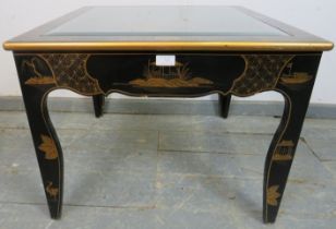 A black and gold lacquer Chinoiserie side table, with inset bevelled glass top, on shaped