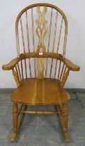 A good quality hand crafted light oak Windsor rocking chair in the 19th century taste, having shaped