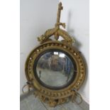 A Regency Period convex girandole wall mirror, within an ornate gilt gesso surround, the cornice