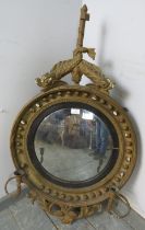 A Regency Period convex girandole wall mirror, within an ornate gilt gesso surround, the cornice